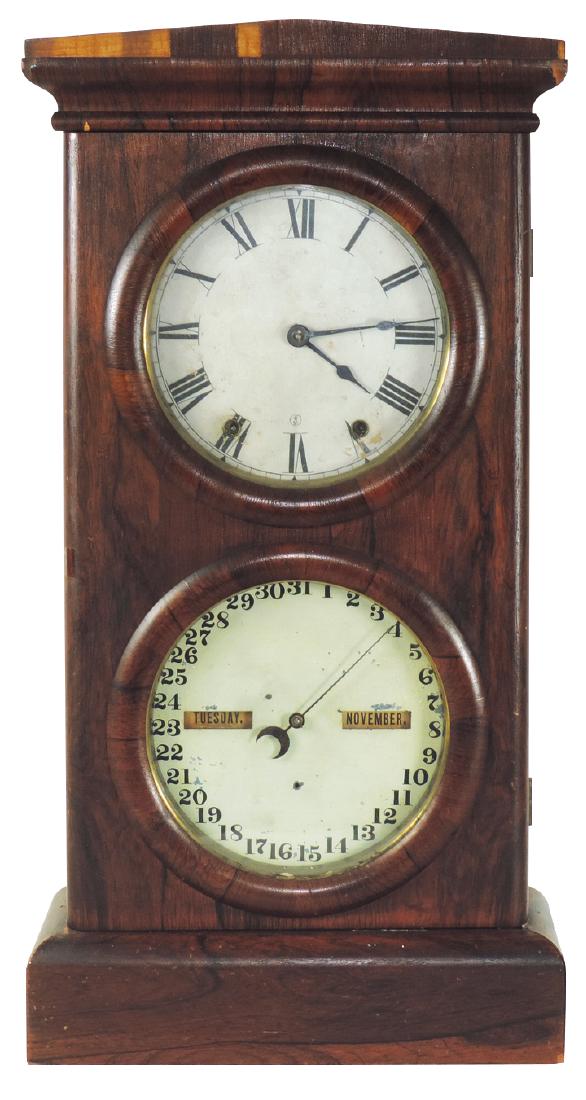 Clock, Seth Thomas double-dial calendar shelf clock: Clock, Seth Thomas double-dial calendar shelf clock w/day, month & date, Rosewood veneer time & strike, c.1880, VG orig wkg cond w/some missing veneer, 27"H x 13.5"W x 5"D.