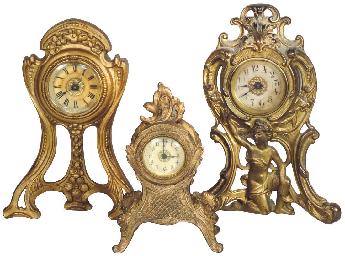 Clocks (3), Victorian mantle or desk clocks, brass: Clocks (3), Victorian mantle or desk clocks, brass Westclox alarm w/semi-nude lady, dated 1906, cast iron Western Clock Co. & smaller unmarked cast iron, all in VG wkg cond, 8" to 11"H.
