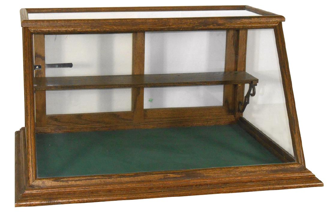 Country store countertop showcase, oak slant top,: Country store countertop showcase, oak slant top, custom made w/shelf & wood brackets, a great look & size, Exc cond w/lock & key, 18"H x 36"W x 24"D.