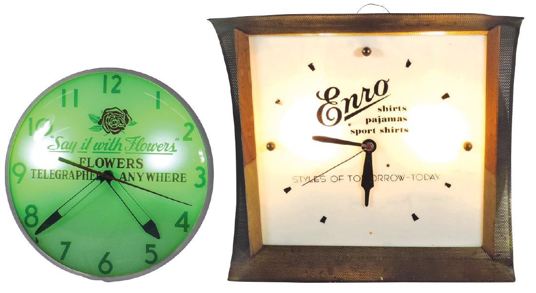 Advertising clocks (2), "Say it with Flowers" lightup,: Advertising clocks (2), "Say it with Flowers" lightup, mfgd by Electric Time Co., Inc., VG wkg cond, 15"Dia & "Enro Shirts, Pajamas & Sport Shirts," wood & metal case, Good wkg cond, 18"H x 19.5"W.