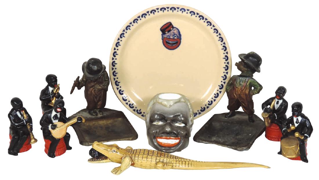 Black Americana items (6), 2 Black cigar-smoking: Black Americana items (6), 2 Black cigar-smoking children bobble-head ashtrays, Black man match holder-ceramic w/striker on back, Coon Chicken Inn 6" plate, Celluloid alligator w/Black man pencil in m
