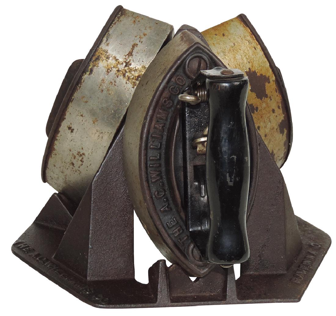 Country store sad iron display, mfgd by The A.C.: Country store sad iron display, mfgd by The A.C. Williams Co.-Ravenna, O., triangular cast iron stand that holds 3 A.C. Williams Co. irons, 1 w/wood handle, Exc cond w/irons showing some signs of use,