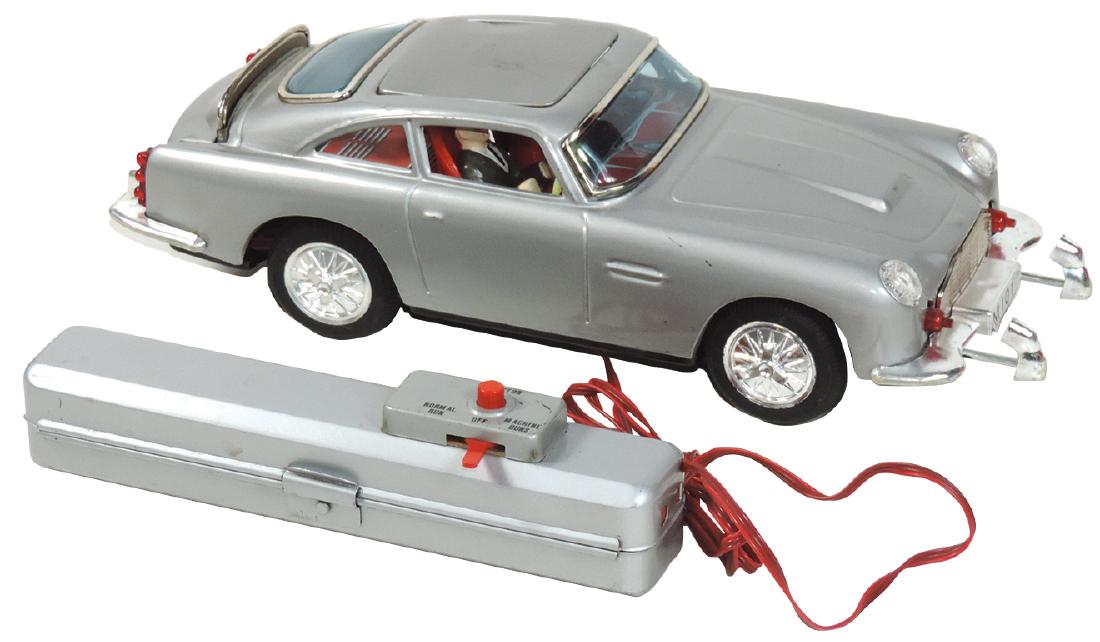 Toy James Bond Aston Martin DB4, mfgd by Gilbert, tin: Toy James Bond Aston Martin DB4, mfgd by Gilbert, tin battery-operated remote control car w/ejector seat, machine guns & back shield, Exc cond, 11.5"L.