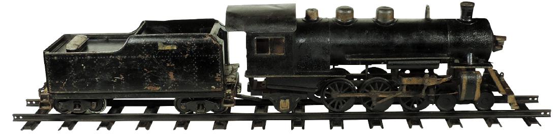 Toy Buddy "L" Outdoor Railroad locomotive, tender & tra: Toy Buddy "L" Outdoor Railroad locomotive, tender & track (3), painted pressed steel, missing bell & has dent in roof, o/wise VG weathered cond, 26" & 17.5"L, comes w/1 section of early 48" track stam
