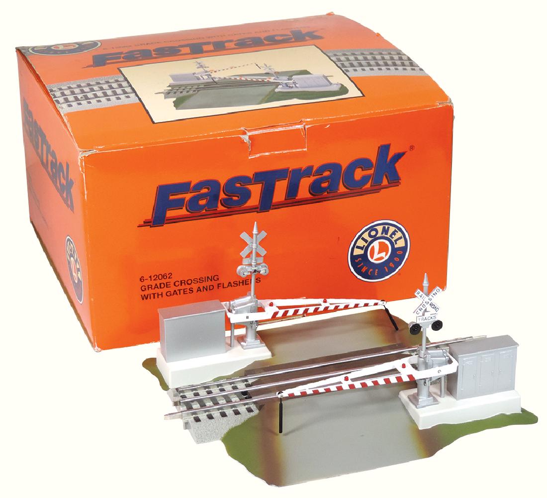 Toy Lionel train accessory, "Fastrack" 6-12062 grade: Toy Lionel train accessory, "Fastrack" 6-12062 grade crossing with gates & flashers, plastic & metal, NOS in orig box, box 7.5"H x 13"W.