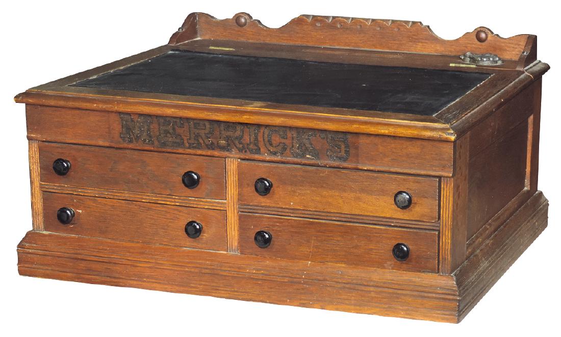 Country store spool cabinet desk, Merrick's, oak: Country store spool cabinet desk, Merrick's, oak 4-drwr, hinged lift lid w/leather-like insert, paneled sides & front, orig carved galley & fancy cast iron ink well, c.1910-1915, VG+ cond w/orig surfa