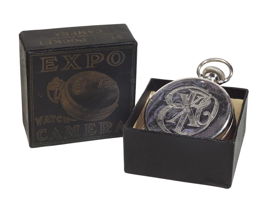 Camera, Expo Vest Pocket Camera in orig box, Rare, made: Camera, Expo Vest Pocket Camera in orig box, Rare, made by The Expo Camera Co.-N.Y., c.1911, metal case w/engraved "EXPO" front, made to appear as a pocket watch, both box & camera in Exc cond, box 2.