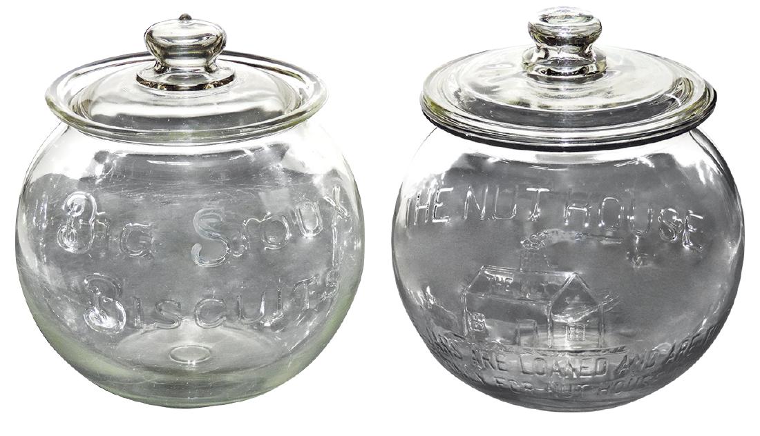 Country store glass counter display jars (2), The Nut: Country store glass counter display jars (2), The Nut House, chip on bottom of lid & Big Sioux Biscuits, roughness on jar collar & lid, o/wise VG cond, each 11.5"H x 10"Dia.