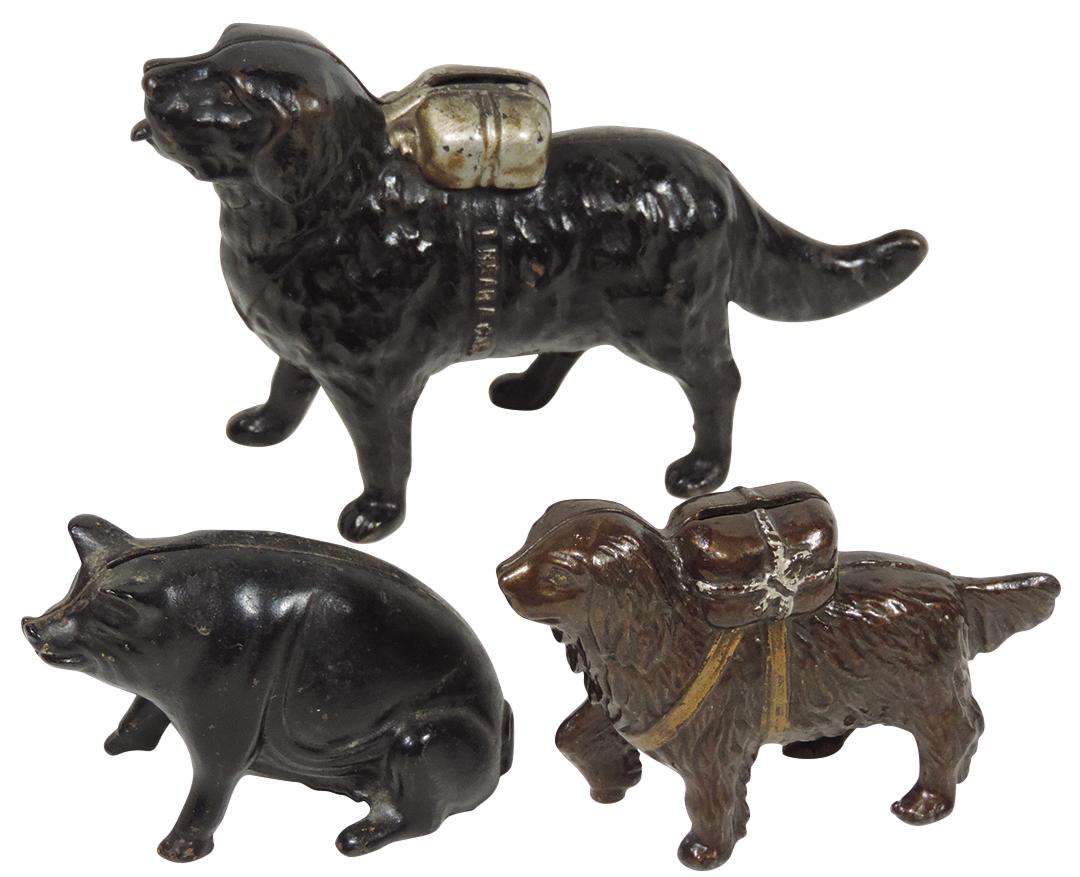 Still banks (3), A. C. Williams "St. Bernard with Pack": Still banks (3), A. C. Williams "St. Bernard with Pack" (small), c.1905, "Water Spaniel with Pack" (I hear a call embossed on side of dog), c.1900 & "Sitting Pig", all painted cast iron in VG to Exc c