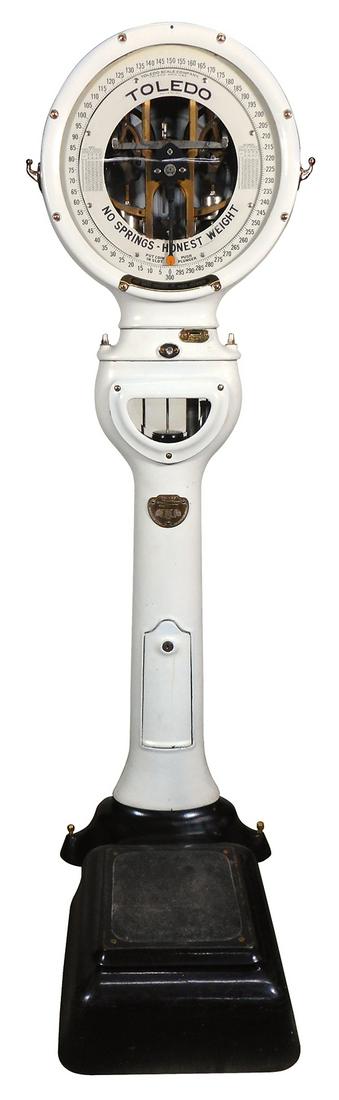 Scale, Toledo lollipop, white porcelain with visible: Scale, Toledo lollipop, white porcelain with visible mechanism, boasts accuracy as doesn't use springs, c.1918, Exc working cond w/minor touchup by lock, 70"H x 19.5"Dia x 29"D.