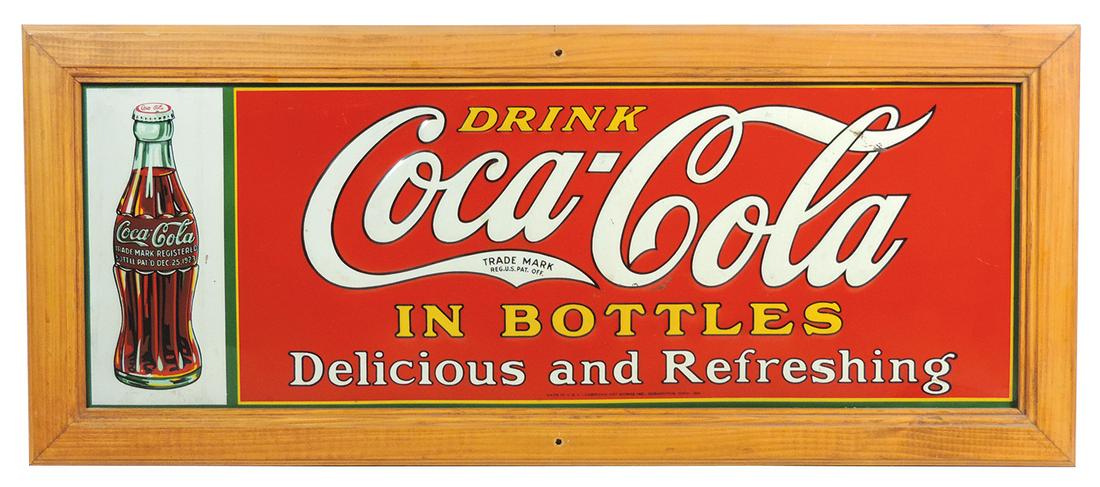 Coca-Cola sign, "Drink Coca-Cola in Bottles Delicious: Coca-Cola sign, "Drink Coca-Cola in Bottles Delicious and Refreshing", embossed metal by American Art Works dated 1931, 1923 Christmas bottle graphic on side, Exc cond in wood frame, 13"H x 30.5"W.