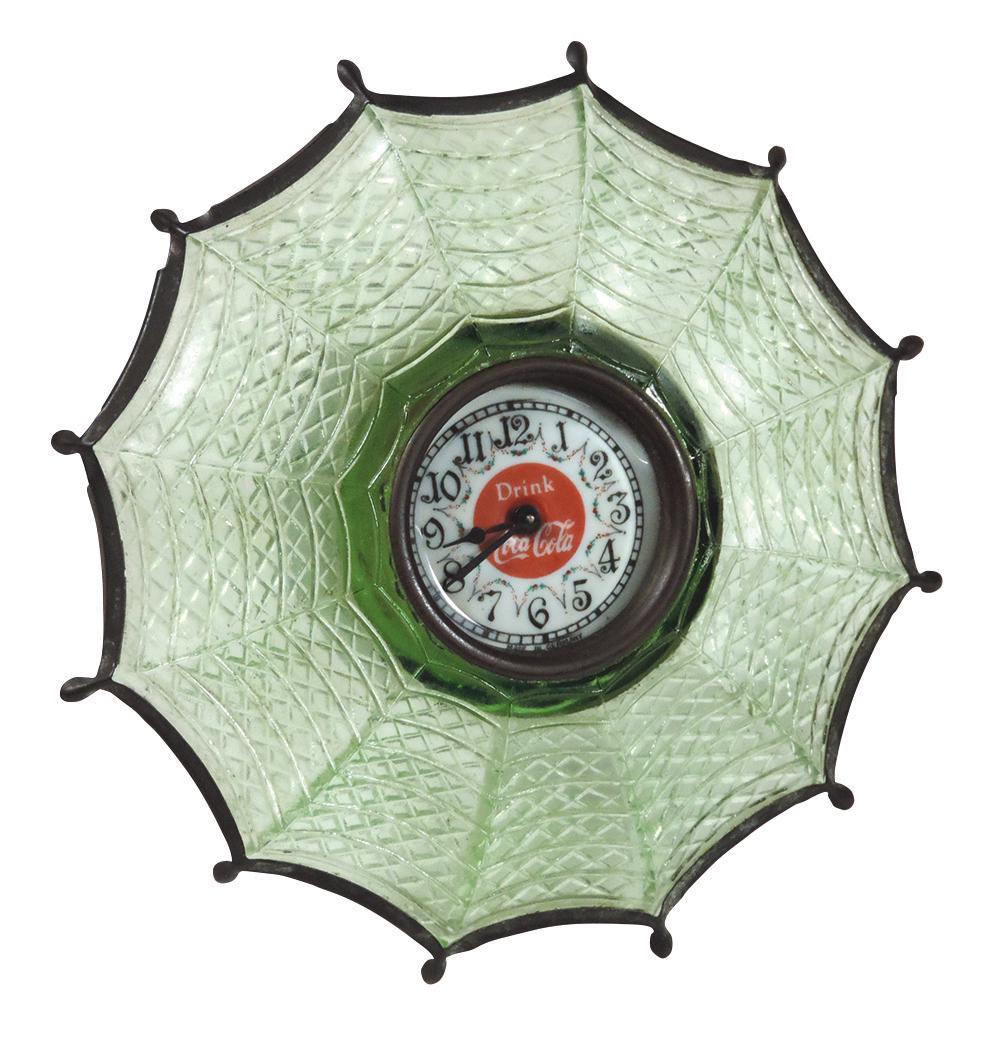Coca-Cola umbrella clock, green pressed glass w/metal: Coca-Cola umbrella clock, green pressed glass w/metal center dial, reads "Drink Coca-Cola", mech appears to work but is difficult to wind, o/wise Exc cond, 6"H x 8"L.