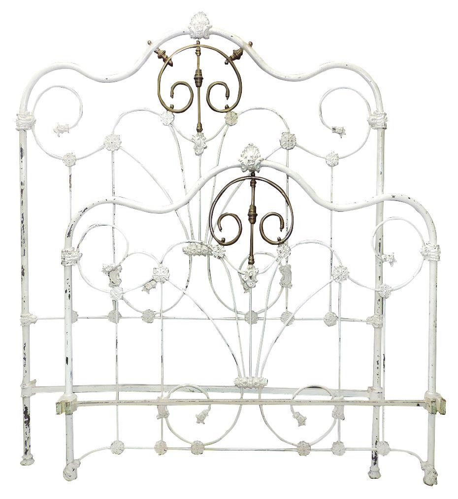 Furniture, cast iron bed w/brass details, full size: Furniture, cast iron bed w/brass details, full size painted white, center fan w/rosette design, VG cond w/chipping paint, headboard 65"H & footboard 47.5"H x 53.5"W, complete w/rails.