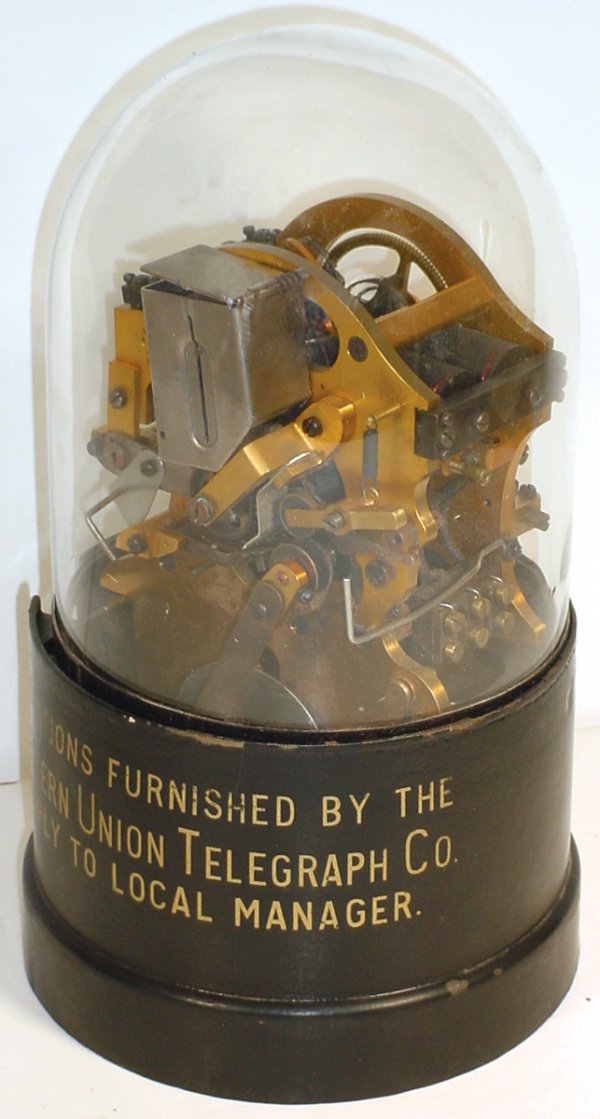 Western Union stock ticker tape machine, mfgd by: Western Union stock ticker tape machine, mfgd by T.A. Edison, cast iron base w/glass dome, used in brokerage houses in the 1920's, Exc orig cond, 14"H x 8"Dia.