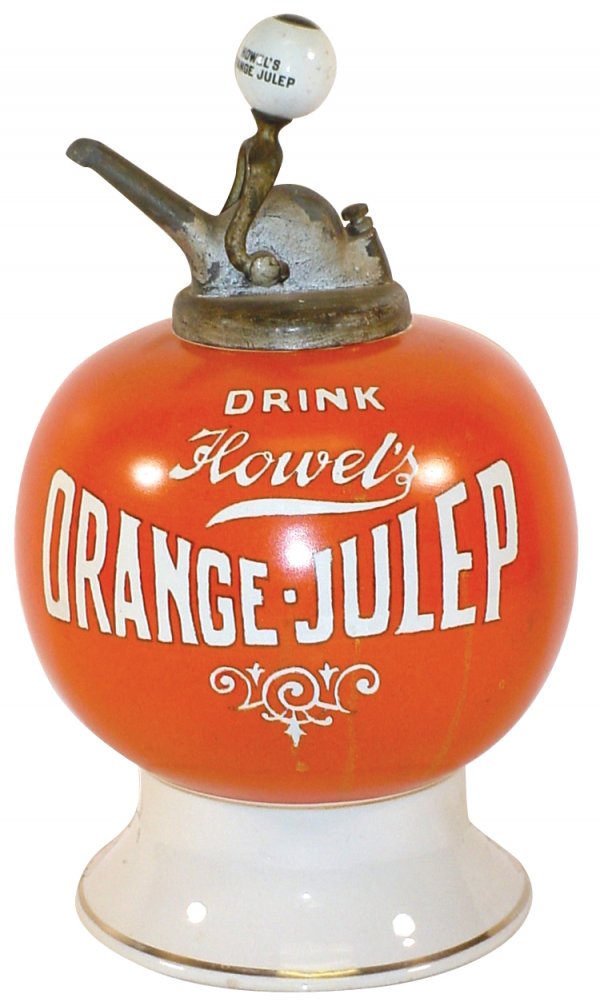 Syrup dispenser, Howel's Orange-Julep, ball shape: Syrup dispenser, Howel's Orange-Julep, ball shape w/bow tie logo, Exc cond w/tiny base chip & drilled hold at bottom of ball at back, correct old pump w/Howel's Orange-Julep ball, 15"H.