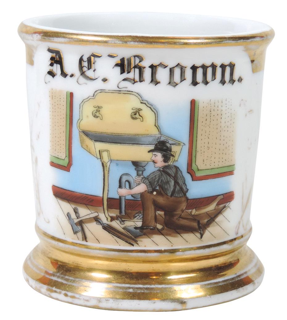 Occupational Shaving Mug, Plumber w/Tools Repairing: Occupational Shaving Mug, Plumber w/Tools Repairing Washroom Sink, decorator's mark on bottom, personalized A. C. Brown, Exc cond w/some wear on gold bands & handle, 3 5/8"H.