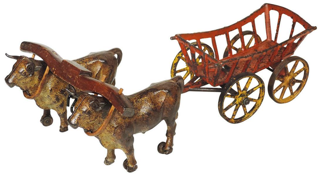 Toy Wagon, Kenton Oxen & loose Hay Wagon & carved wood: Toy Wagon, Kenton Oxen & loose Hay Wagon & carved wood yoke, cast iron w/a nice amount of orig paint, VG cond w/no driver, 14"L.