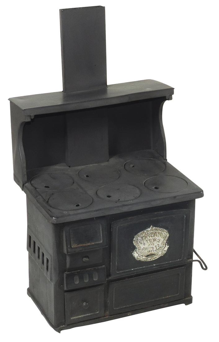Salesman Sample or Child's Stove, "Garland", painted: Salesman Sample or Child's Stove, "Garland", painted tin w/nickel-plated brass emblem, VG cond w/later finish, 16"H x 9"W x 7"D.