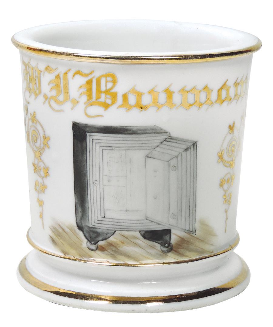 Occupational Shaving Mug, Safe Salesman, early: Occupational Shaving Mug, Safe Salesman, early combination safe on wheels, unmarked bottom, personalized W. J. Bauman, Near-Mint cond w/no loss on gold, 3 5/8"H.
