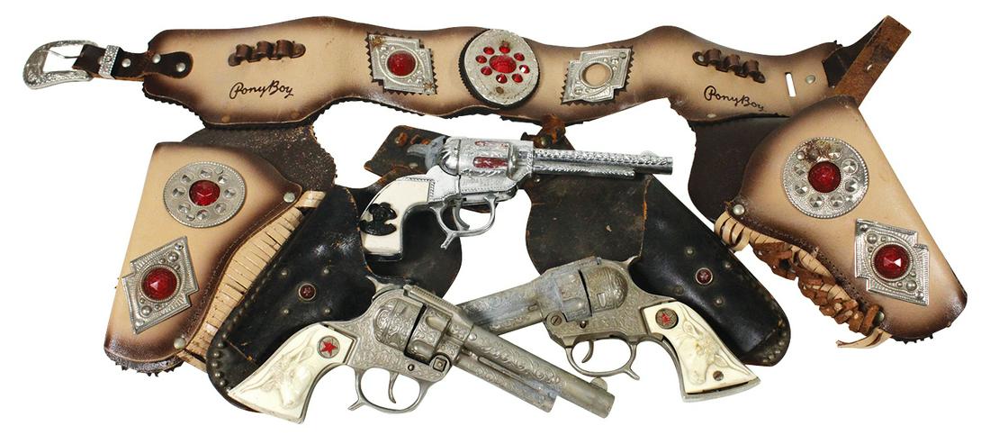 Toy Western Holster & Cap Guns (4), 1960's Leather: Toy Western Holster & Cap Guns (4), 1960's Leather "PonyBoy" double holster/belt, "Hopalong Cassidy cap gun & two beltless holsters w/Texan Jr. pistols, Good to VG cond w/some leather loss to latter.
