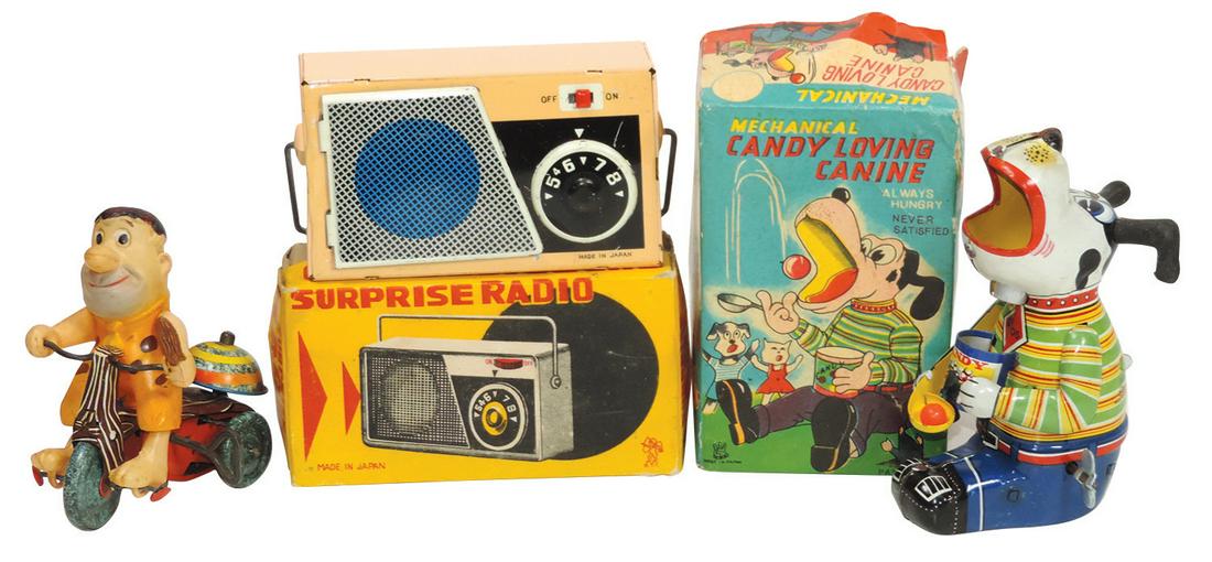 Toys (3), Fred Flintstone on Tricycle by Marx, Candy: Toys (3), Fred Flintstone on Tricycle by Marx, Candy Loving Canine-Japan & Surprise Radio-Japan, two are litho on tin windups, Fred is celluloid, Canine w/orig box & radio is a 1950's gag toy w/orig b