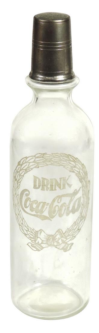 Coca-Cola Syrup Bottle, glass w/enameled "Drink: Coca-Cola Syrup Bottle, glass w/enameled "Drink Coca-Cola" in wreath, complete w/nickeled brass measure, c.1910, Exc cond, 12.5"H.