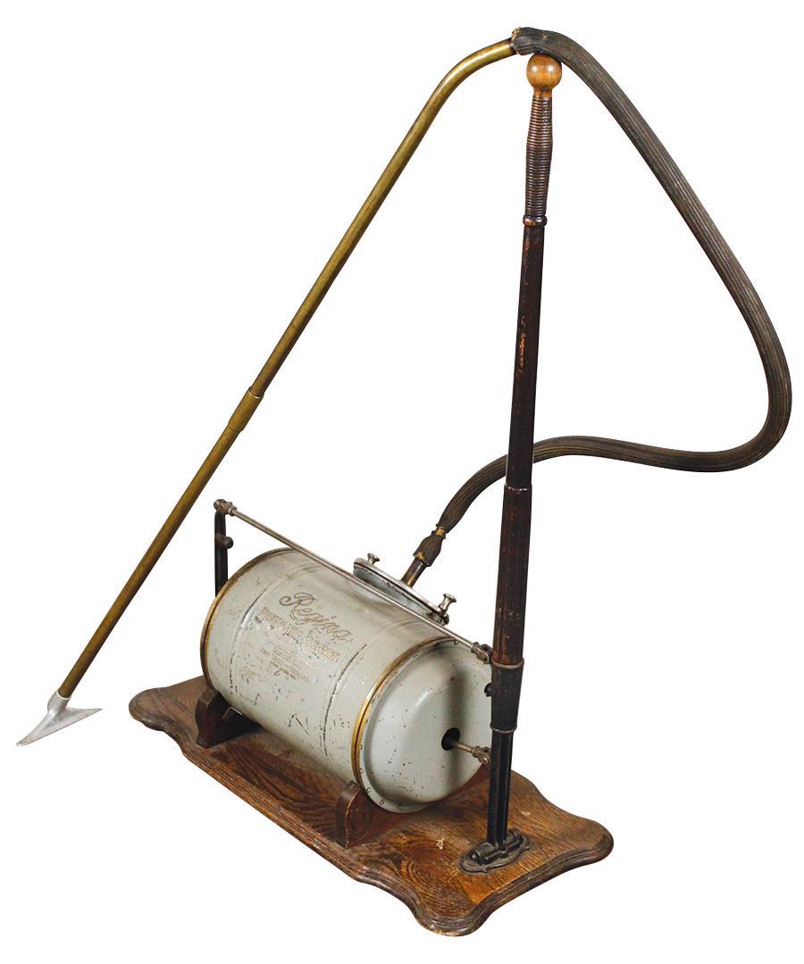 Primitive Vacuum Cleaner, Regina Pneumatic Cleaner,: Primitive Vacuum Cleaner, Regina Pneumatic Cleaner, hand pump canister vacuum, tin & iron w/wood base, orig cond w/wear, brittle hose & weak bellows, 40"H x 28"L x 12"D.