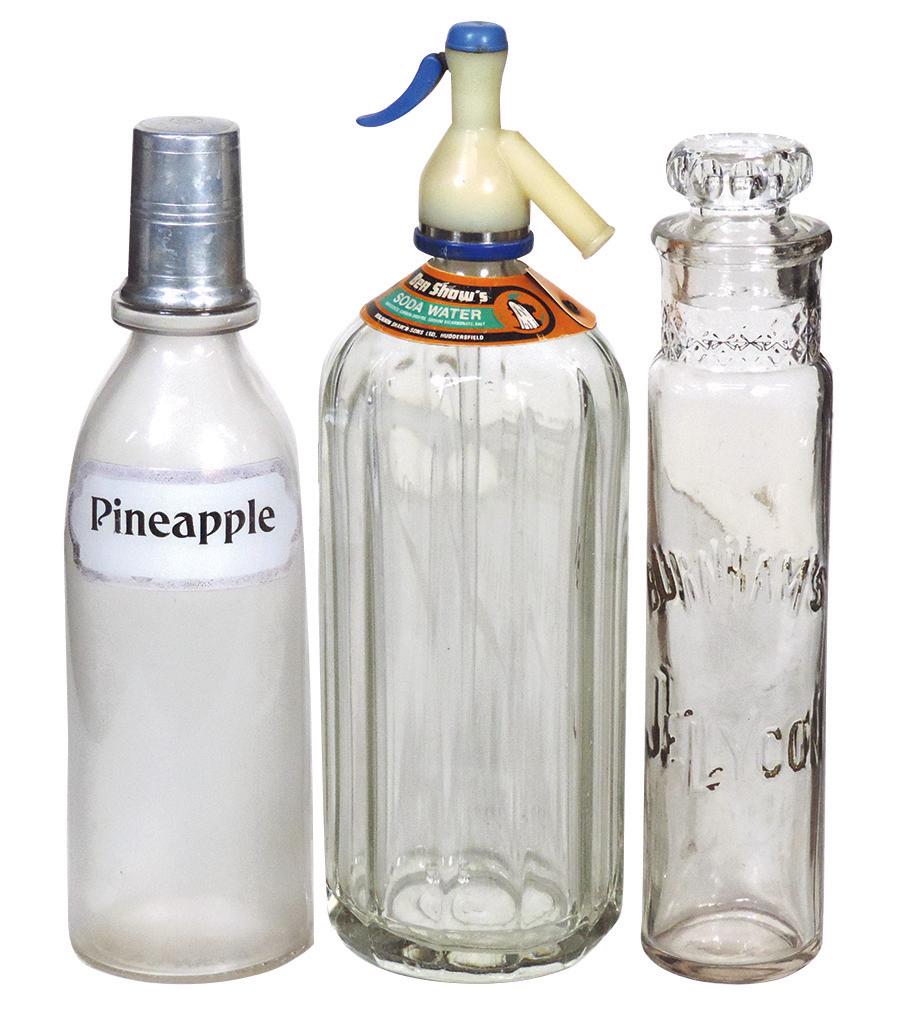 Soda Fountain Back Bar Bottles (3), "Ben Shaw's Soda: Soda Fountain Back Bar Bottles (3), "Ben Shaw's Soda Water" bottle, "Pineapple" syrup bottle w/label under glass by L.A. Becker & an embossed "Burnham's Jellycon" w/later cover, all VG cond, largest 1