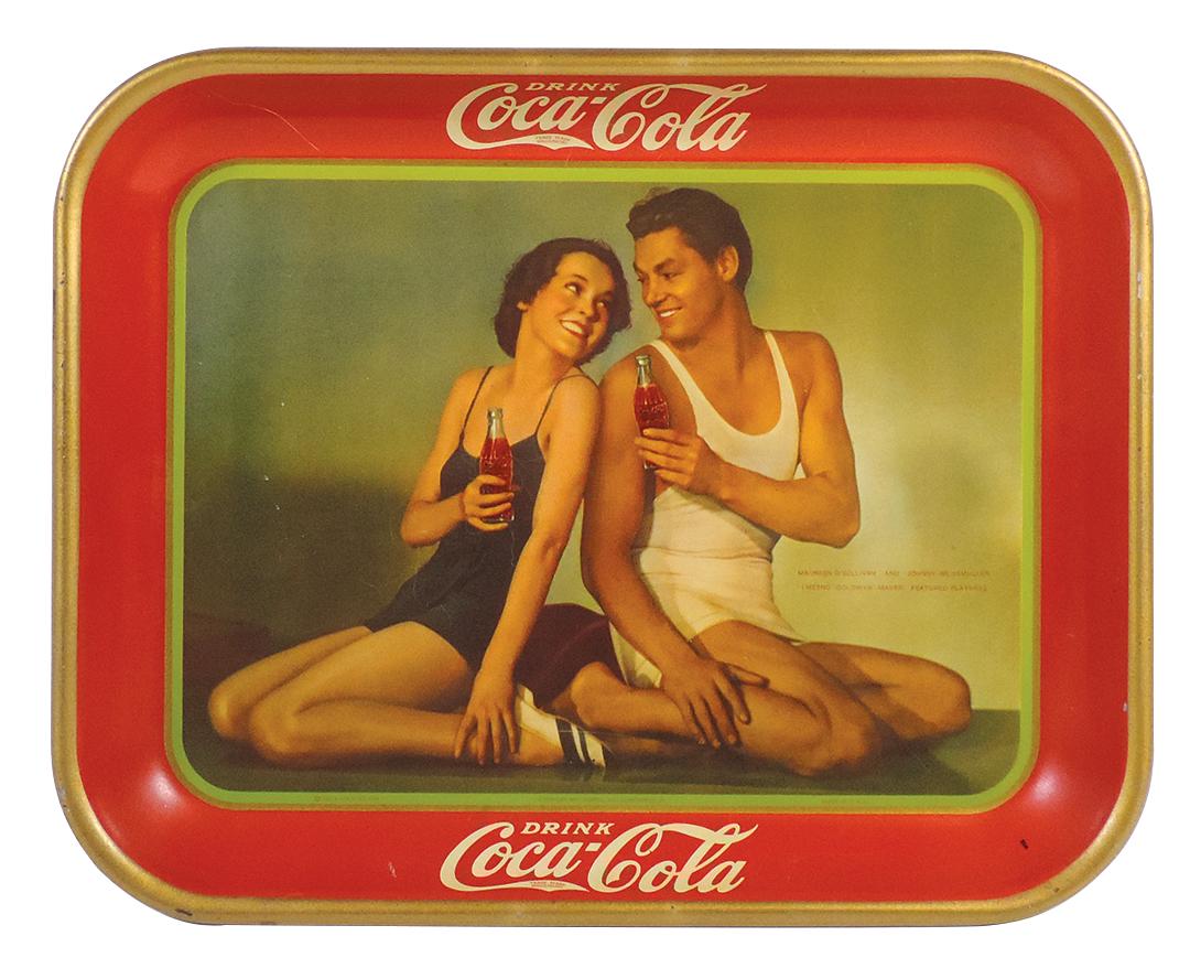 Coca-Cola Serving Tray, 1934, Maureen O'Sullivan &: Coca-Cola Serving Tray, 1934, Maureen O'Sullivan & Johnny Weissmuller Metro-Goldwyn-Mayer Featured Players, litho on metal by American Art Works, Exc+ cond w/great color & gloss, 10.5"H x 13"W.