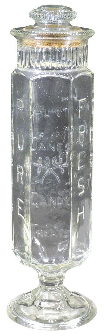 Candy Show Jar, embossed "Aunt Jane's Candy Treats",: Candy Show Jar, embossed "Aunt Jane's Candy Treats", tall glass pedestal jar by Crownford Giftware Corp, VG cond w/minor rim nicks, 16"H.