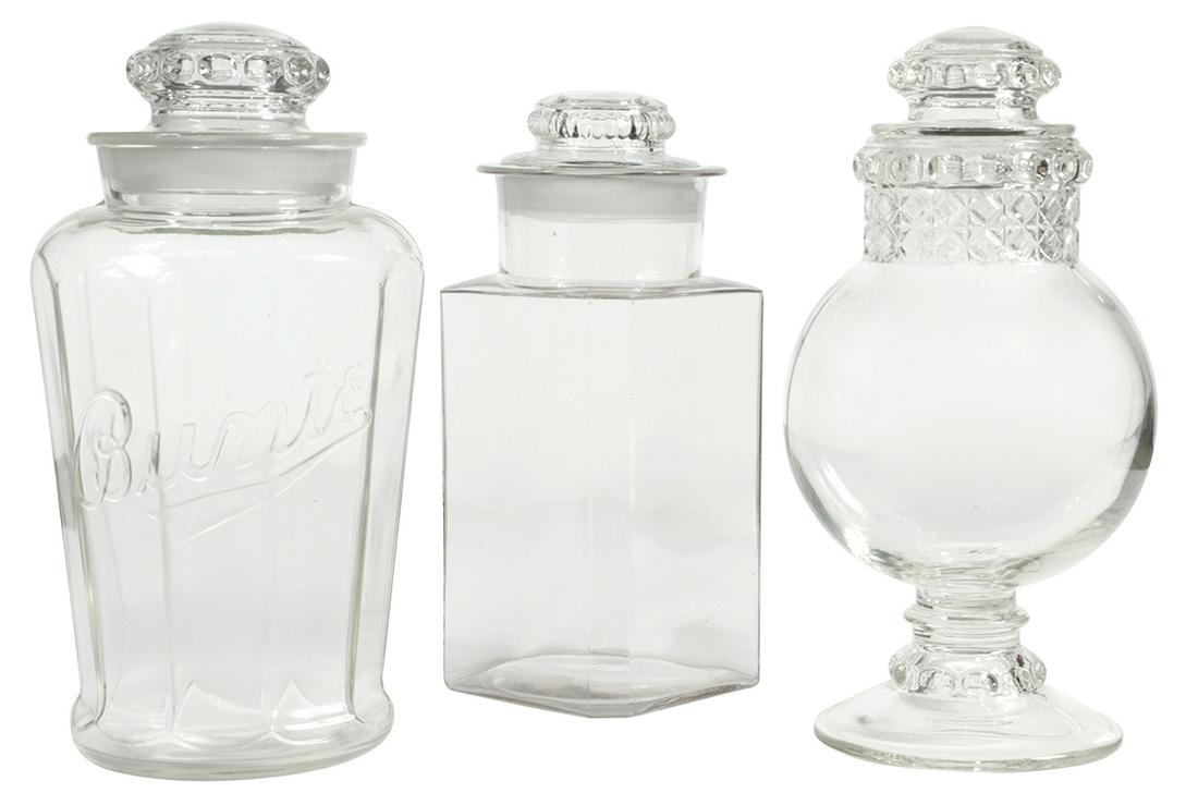Candy Show Jars (3), "Bunte" embossed paneled jar,: Candy Show Jars (3), "Bunte" embossed paneled jar, Dakota globe & square jar w/chamfered corners, all w/lids, VG & Exc cond, globe jar w/minor roughness on lip, largest 11.5"H.