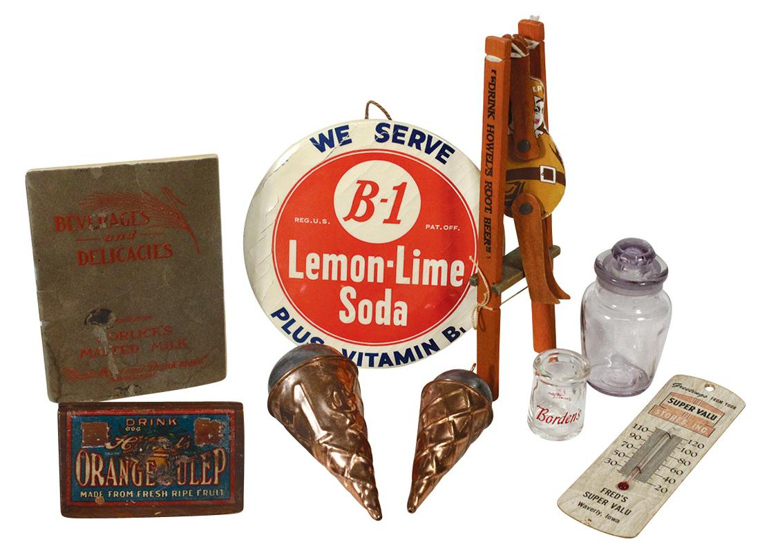 Soda Fountain Items (9), B-1 Lemon-Lime Soda celluloid: Soda Fountain Items (9), B-1 Lemon-Lime Soda celluloid button, 2 embossed tin ice cream cone hanging pendants, Orange-Julep wood placard stand, Howel's Root Beer toy acrobat & other related items, all