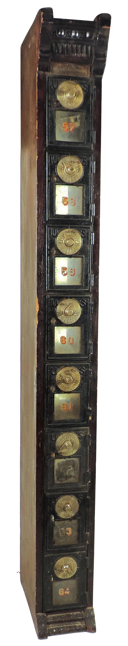 U.S. Post Office Box Column, Early 20th Century, mfgd: U.S. Post Office Box Column, Early 20th Century, mfgd by McLane Mfg.-Chicago, Ill, 8 cast iron doors w/combination locks in a mixed wood frame, sight glasses numbered 57 through 64, brass maker's tag,