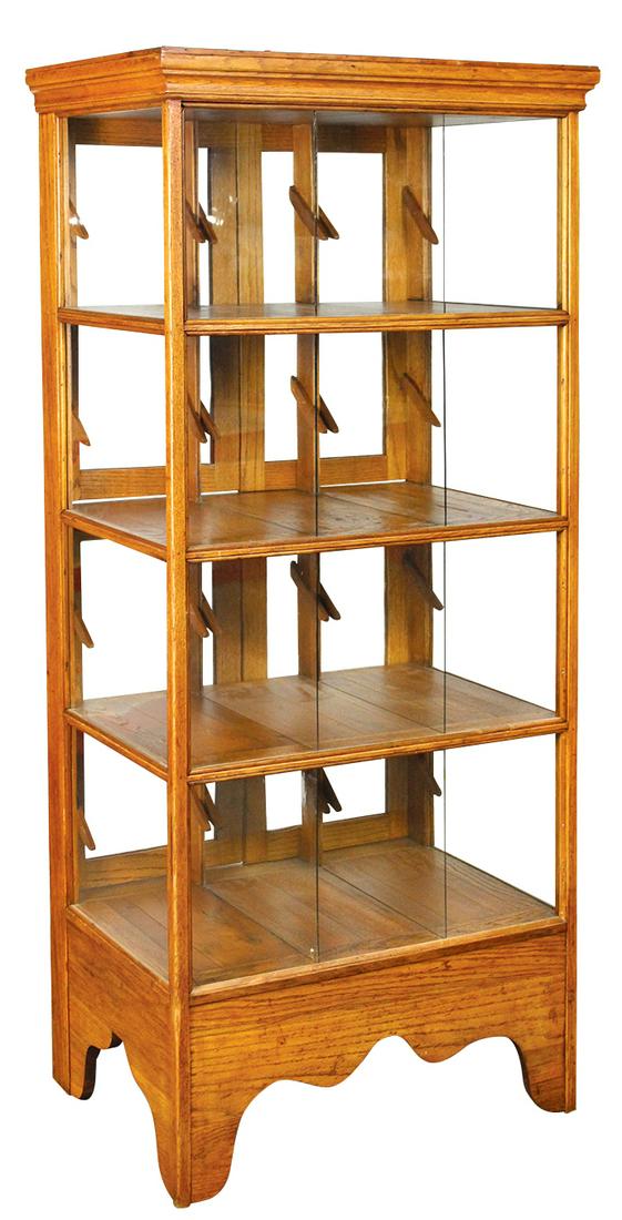 Country Store Oak Shirt Display Case, 4 shelves, each: Country Store Oak Shirt Display Case, 4 shelves, each w/angled risers, 7 glazed divisions for three shirts, raised on scalloped bracket feet, 4 doors at rear w/push-button pulls, c.1900, Exc refinishe