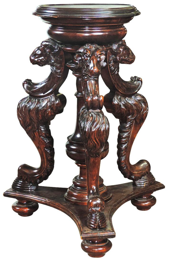 Furniture, Renaissance Revival Ram's Head Carved Stand,: Furniture, Renaissance Revival Ram's Head Carved Stand, hardwood w/mahogany finish, 3 massive carved Ram heads & leg supports on a triangular base, VG cond noting later refinish & a few shrinkage spli