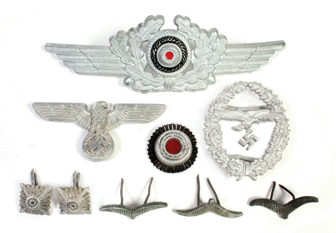 Militaria, German WW2 Luftwaffe Insignia (9), various: Militaria, German WW2 Luftwaffe Insignia (9), various die-stamped aluminum & cast devises, including a visor hat cap badge, SA Eagle cap badge stamped rz-mi-157, an oak leaf & eagle badge plus various