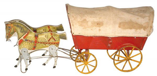 Toy, horse-drawn covered wagon, The Gibbs Mfg Co.: Toy, horse-drawn covered wagon, The Gibbs Mfg Co.-Canton, O., copyrighted 1910, paper litho over wood horses w/metal legs, wagon is metal w/orig cloth cover, Good cond, 9"H x 18"L.
