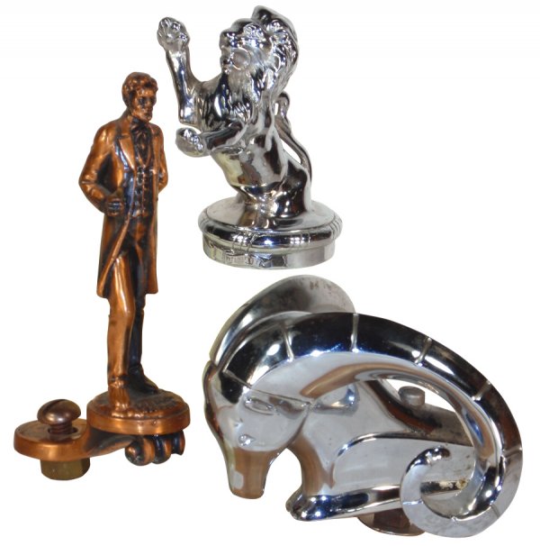 Automobile hood ornaments (3), Abraham Lincoln, m: Automobile hood ornaments (3), Abraham Lincoln, marked Lebarrick Byron II, c.1927, 6"H, Dodge Rams Head, back portion cut off, 3"H & chrome standing lion marked Aura Vincit sterling bronze, NY, NY, 4"