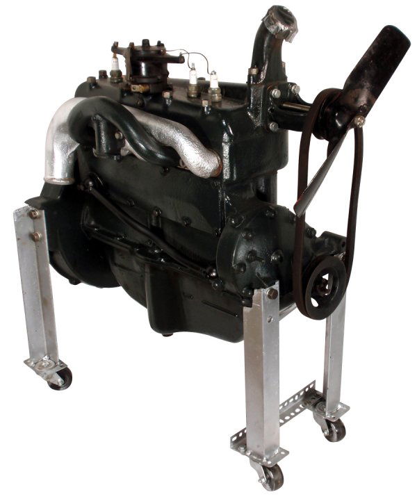 Automobile engine, Ford Model A display engine on: Automobile engine, Ford Model A display engine on customer made stand w/rollers, Exc cosmetically restored cond, 32"L x 14"W.