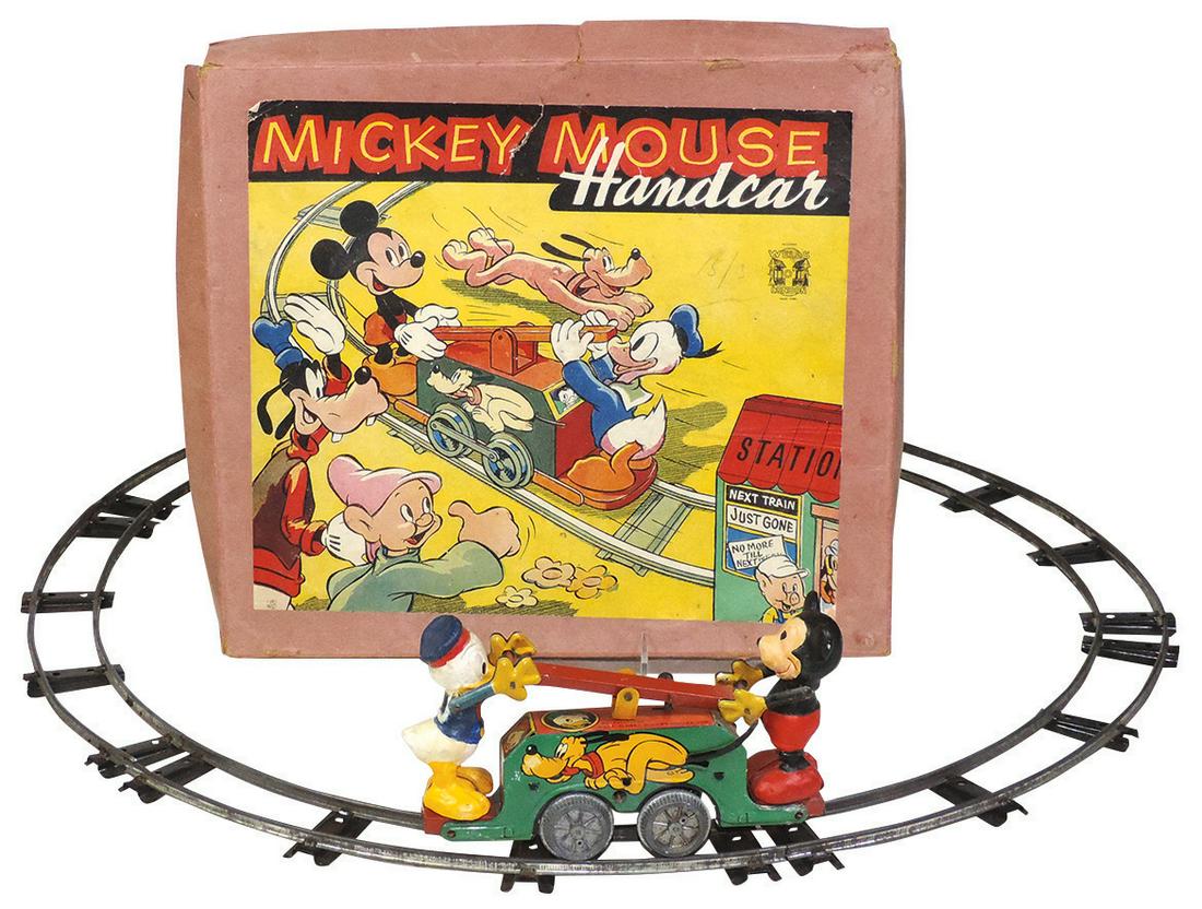 Toy Disney's Mickey Mouse Hand Car, mfgd by Wells of: Toy Disney's Mickey Mouse Hand Car, mfgd by Wells of London, boxed set w/round sectional track, litho buildings absent, Exc working cond w/some light wear, key missing, 12"H x 14"W.