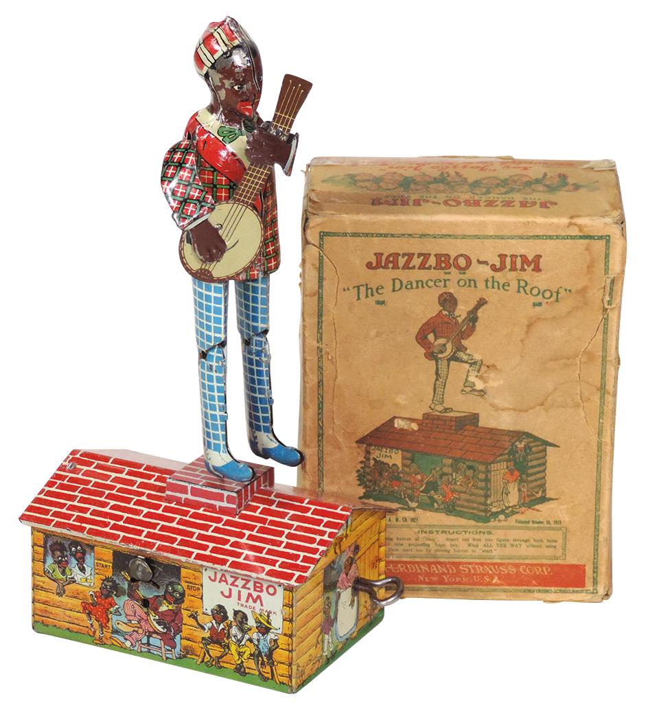 Toy Black Americana Jazzbo Jim, litho on tin windup: Toy Black Americana Jazzbo Jim, litho on tin windup w/orig box, mfgd by Ferdinand Strauss, c.1929, Exc working cond noting some finish loss to one side of face & wear on box, 10.5"H x 5"W x 3"D.