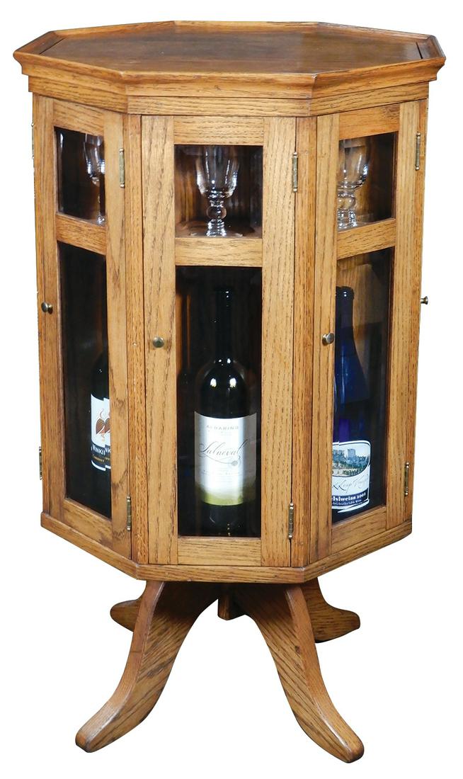 Revolving Wine Cabinet, high quality crafted solid oak: Revolving Wine Cabinet, high quality crafted solid oak octagonal cabinet w/beveled glass doors on 4-legged revolving base, wine bottle compartments below individual wine glass shelves, includes 8 matc
