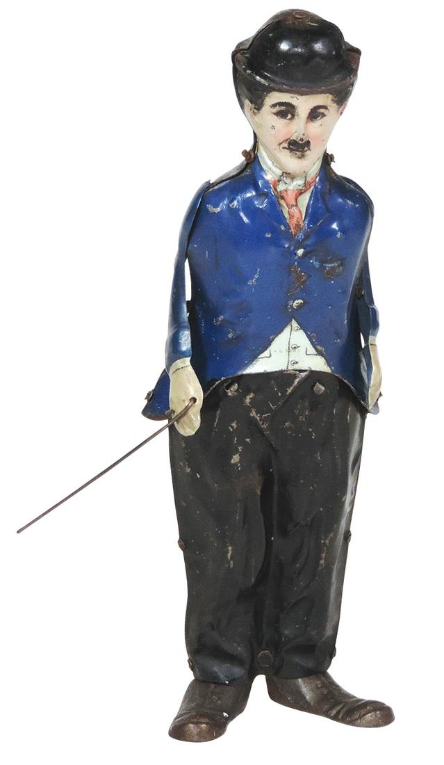 Toy Charlie Chaplin windup, painted tin clockwork: Toy Charlie Chaplin windup, painted tin clockwork walker w/cast iron shoes, mfgd by B & R -U.S.A., VG+ working cond w/some edge wear, paint chips & minor oxidation to hat, 8.5"H.