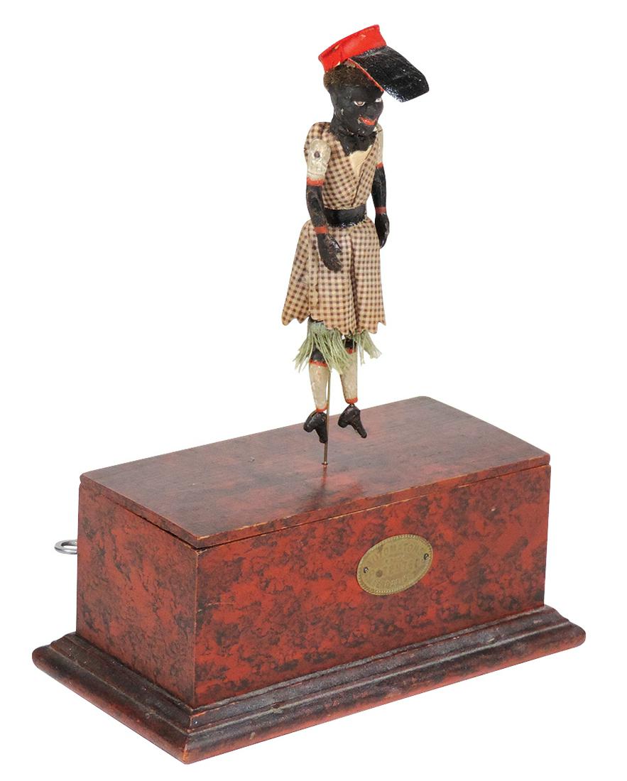 Toy Automaton, Black Minstrel Jigger, 19th C. clockwork: Toy Automaton, Black Minstrel Jigger, 19th C. clockwork drive, mfgd by La Grove, Kemp & Webb-Broadway, New York, painted composition & cloth figure w/works contained in a faux tortoise finish wood cas