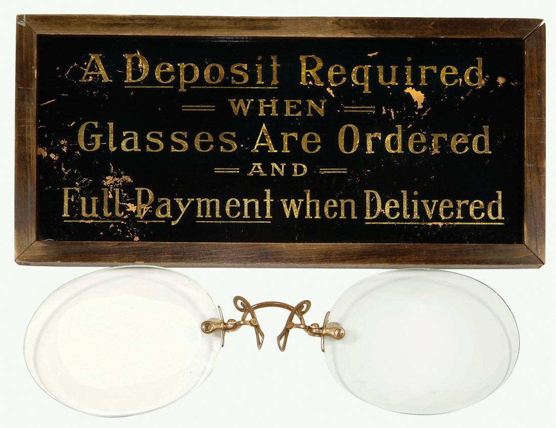 Optometrist Sign & Glasses (2), "A Deposit Required: Optometrist Sign & Glasses (2), "A Deposit Required When Glasses Are Ordered and Full Payment When Delivered", reverse paint on glass w/gold lettering, VG cond w/scattered background paint loss, 7"H x
