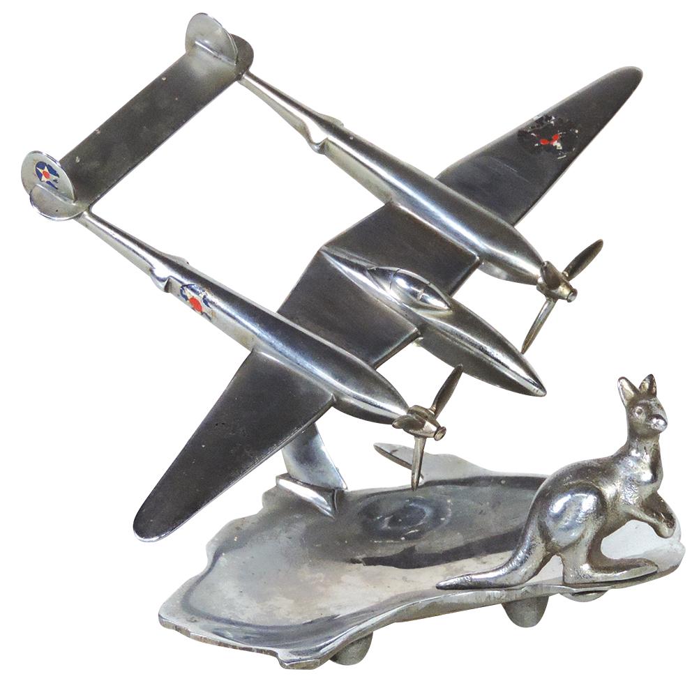 Militaria Tray, WWII 5th Airforce 1942-1945, souvenir: Militaria Tray, WWII 5th Airforce 1942-1945, souvenir of Australia, modeled as cast metal P-38 w/U.S. insignia above shallow bowl-shaped as the Australian continent & mounted w/figural kangaroo, perio