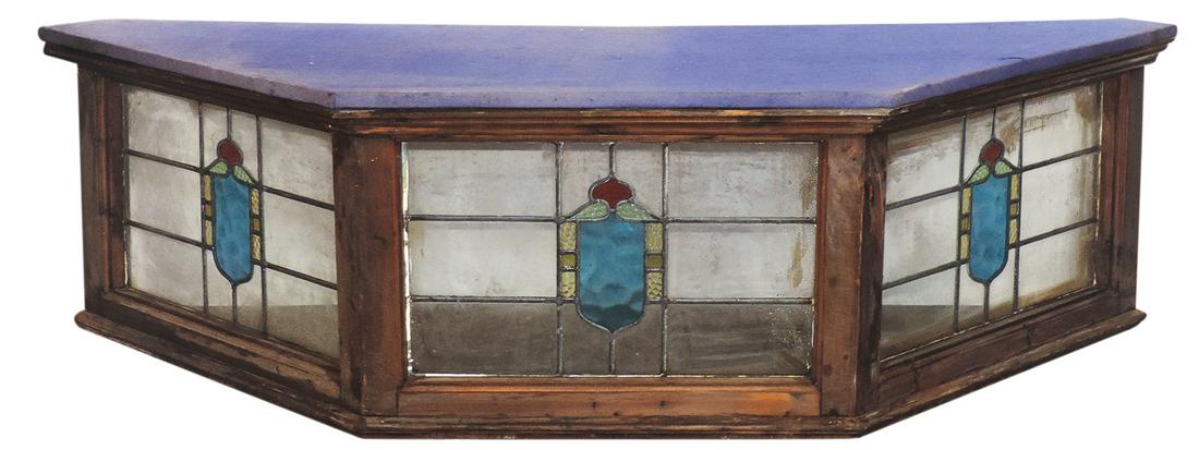 Architectural Stained Glass Bay Window, 3 leaded glass: Architectural Stained Glass Bay Window, 3 leaded glass panels w/stylized armorial crests in a pine cased frame w/later wood & glass top, VG cond w/one cracked tile, 23"H x 78"W x 25"D.