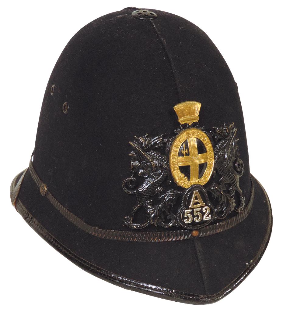 Militaria English Bobby Helmet, wool felt covered w/City of London embossed badge numbered A552, VG: Militaria English Bobby Helmet, wool felt covered w/City of London embossed badge numbered A552, VG cond w/normal wear, 8"H x 11.5"L.