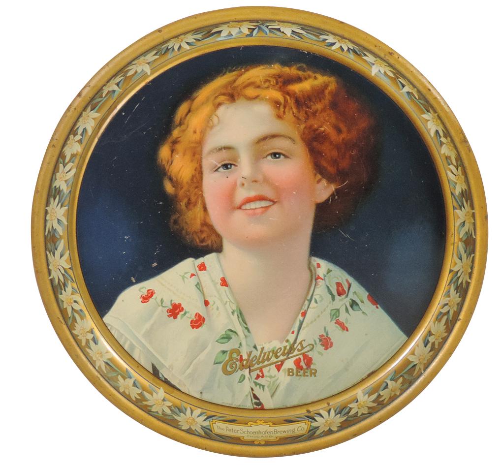 Breweriana Tray, Edelweiss Beer, litho on tin scene of young girl w/edelweiss blossom border by: Breweriana Tray, Edelweiss Beer, litho on tin scene of young girl w/edelweiss blossom border by P.S.B. Co., 1913, VG+ cond w/light wear & scuffing, 13"Dia.