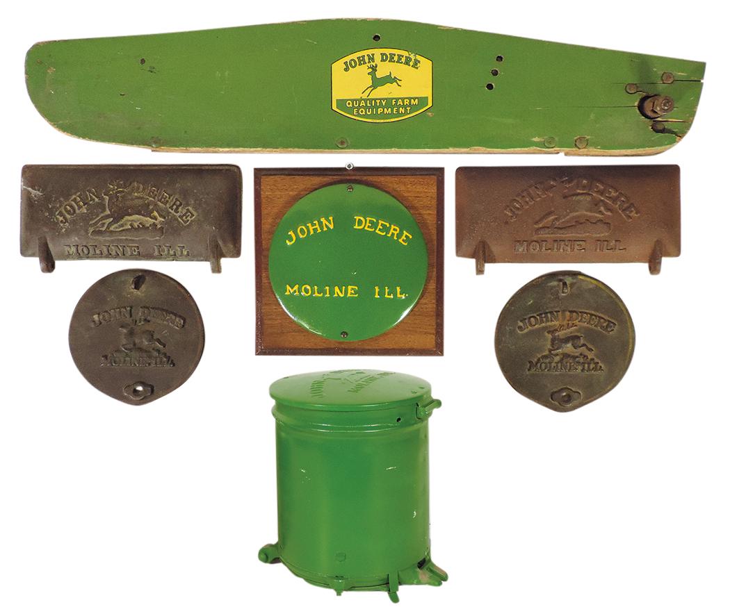John Deere Equipment (7), wood swath board w/decal logo, seed can w/embossed tin cover, 4 embossed: John Deere Equipment (7), wood swath board w/decal logo, seed can w/embossed tin cover, 4 embossed cast iron seed covers & embossed tin cover on wood plaque, Good to Exc cond, largest 34"L.